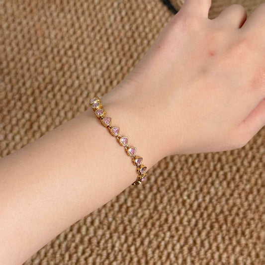 Heartline Pink Bracelet worn alone on the wrist with repeating pink heart-shaped cubic zirconia