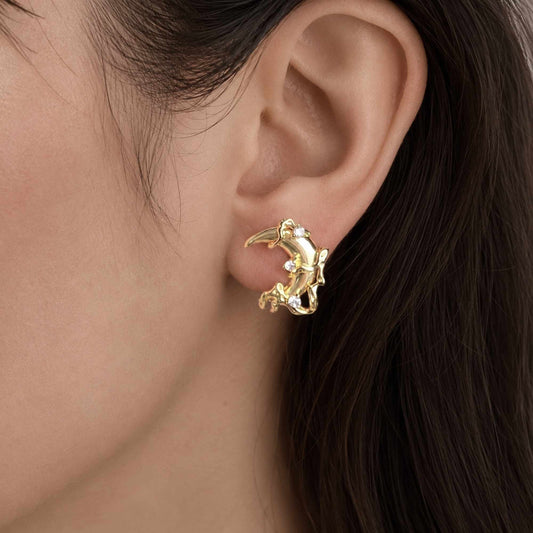 Model wearing gold moon earrings with small zircon details.