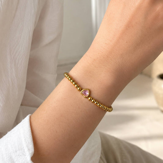 One Heart Bead Bracelet worn alone on the wrist with the pink heart centerpiece facing forward