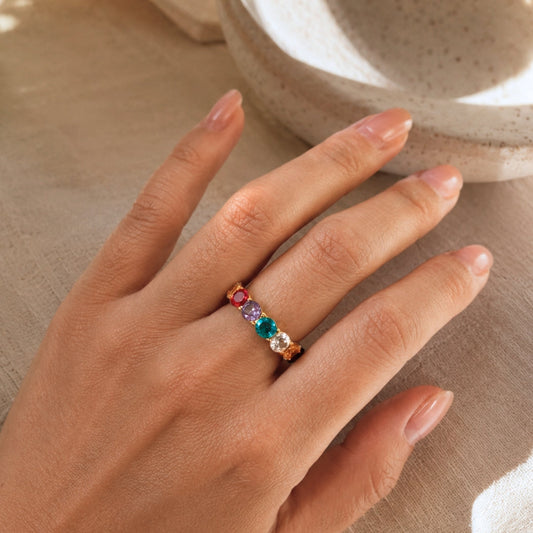 Colorful CZ ring worn on the hand in warm natural light