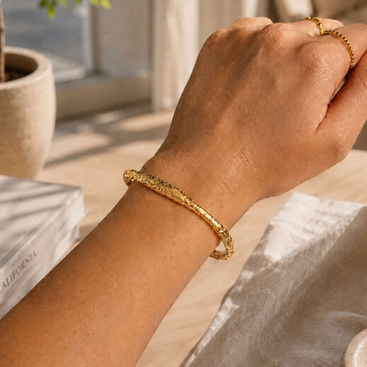 Waterproof gold stainless steel cuff bracelet styled with everyday rings