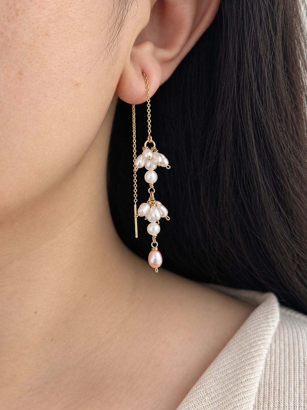 Drift freshwater pearl threader earring worn in side profile with fine gold chain and layered pearl clusters.