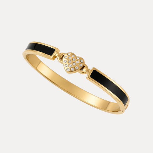 Angled view of the Blackline Heart Bangle with black enamel panels, gold-tone edges and a cubic zirconia heart