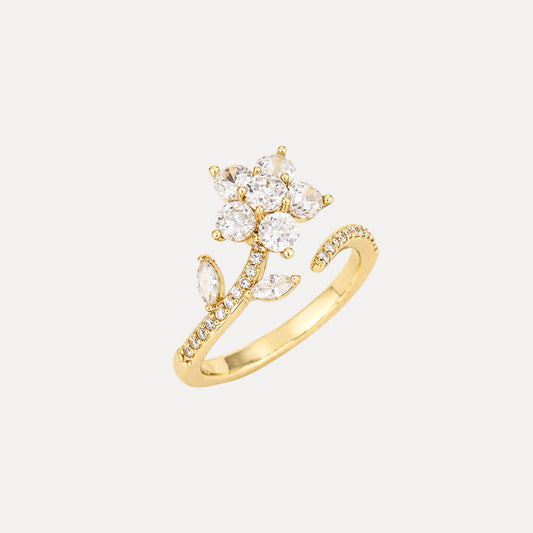 Gold adjustable flower ring with clear zircon stones and a rotating floral detail.