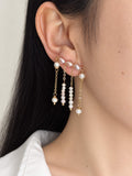Contour freshwater pearl ear climber worn along the earlobe with four delicate pearl and chain drops.