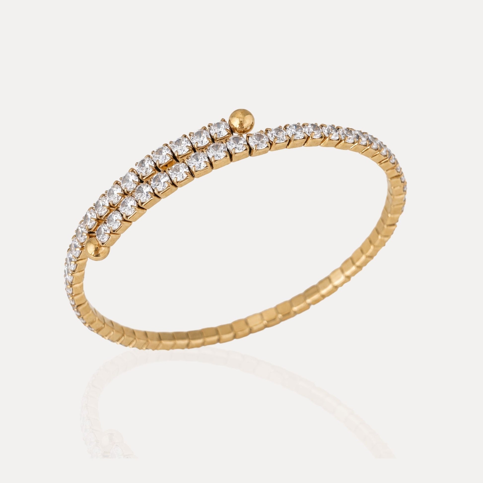 Angled view of the Crossline CZ Bracelet with overlapping double rows of cubic zirconia and gold-tone bead details