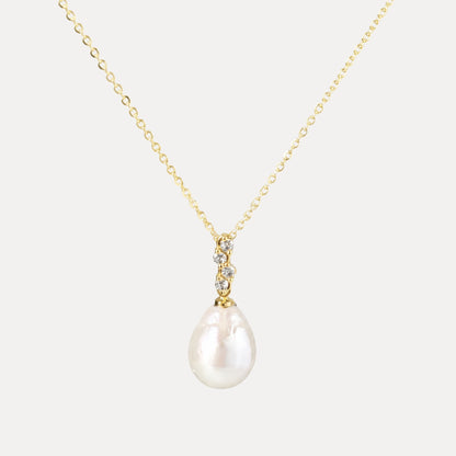 Elara baroque freshwater pearl and cubic zirconia pendant necklace with light gold-plated chain on a soft neutral background