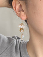 Gleam citrine and freshwater baroque pearl earring worn in side profile with a long gold chain drop.