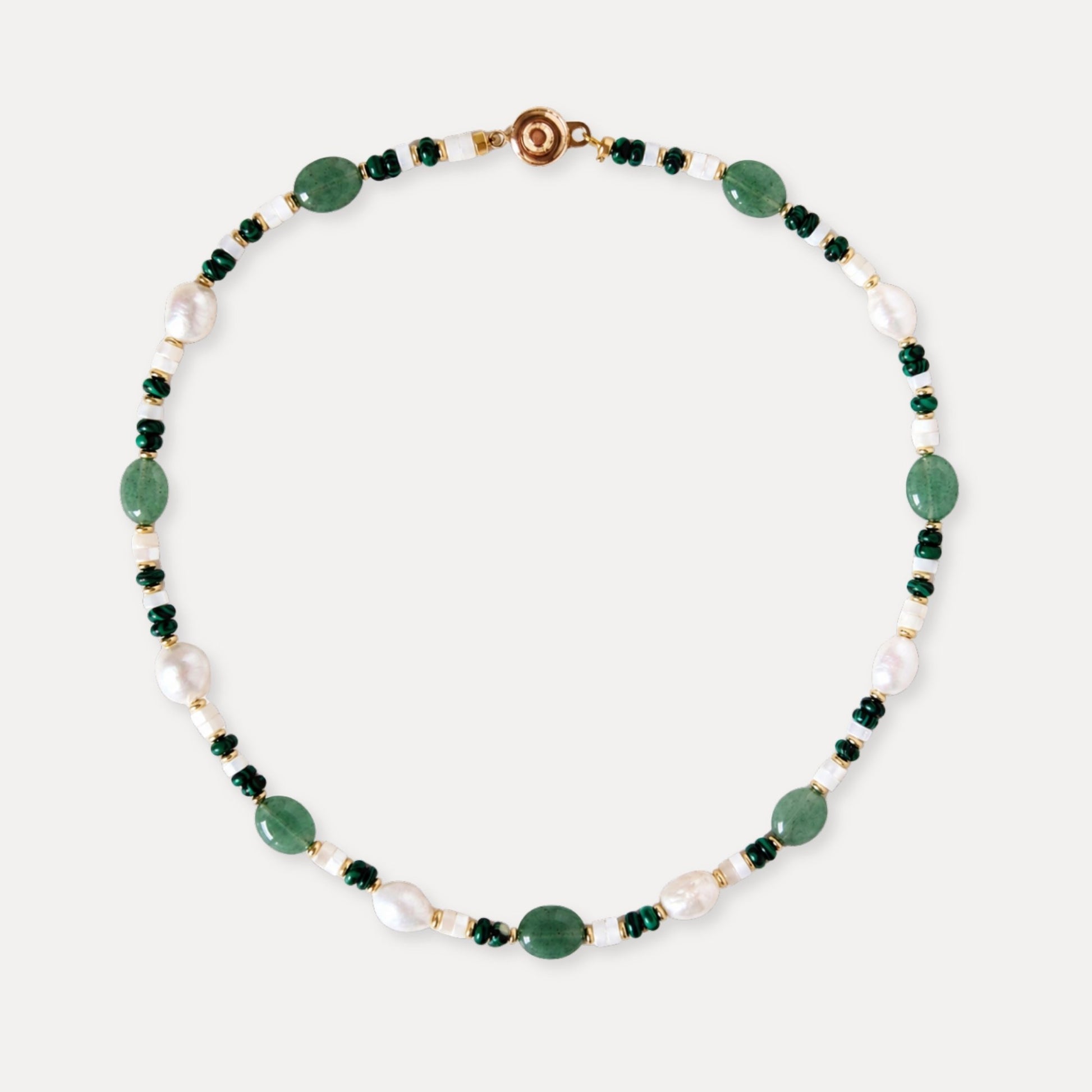 Green aventurine, malachite, and freshwater pearl necklace arranged on a clean light background.
