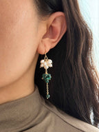 Grove malachite and freshwater pearl drop earring worn in side profile, showing the layered green and white clusters.