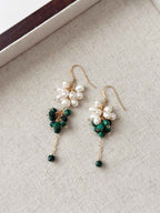 Grove natural malachite and pearl earrings arranged on a neutral linen jewelry tray.