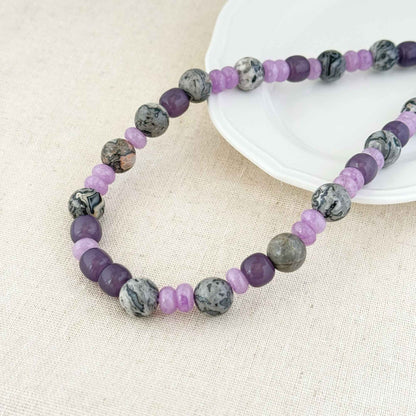 Close-up of lilac purple quartzite beads and gray map stone beads with natural patterns.