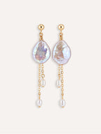 Pair of Lilt baroque pearl drop earrings with 14K gold-filled chains and staggered pearl accents.