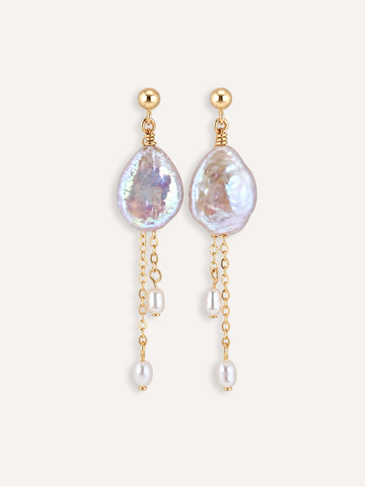 Pair of Lilt baroque pearl drop earrings with 14K gold-filled chains and staggered pearl accents.