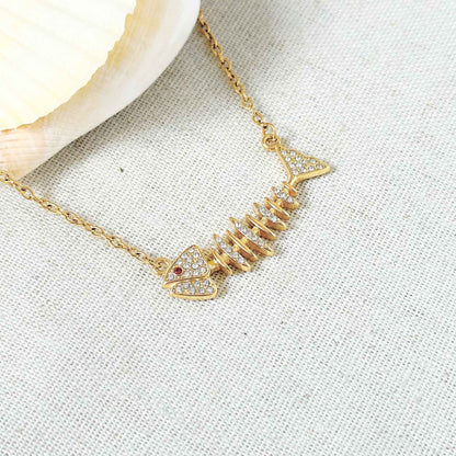 Close-up of the fishbone pendant with clear zirconia stones and a tiny red accent.