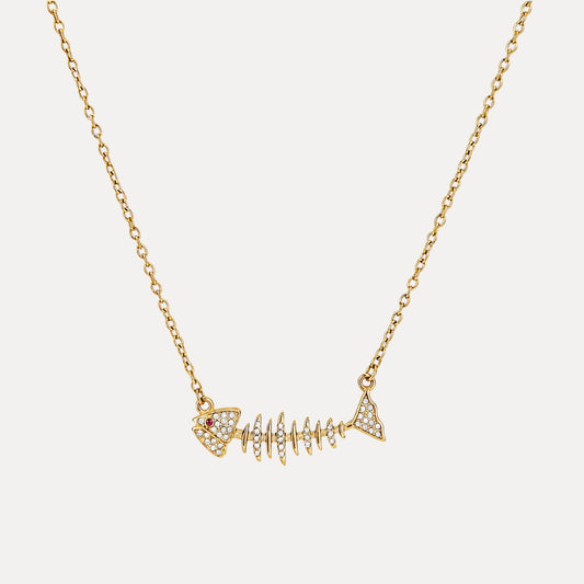 Gold fishbone charm necklace with cubic zirconia details on a soft light background.