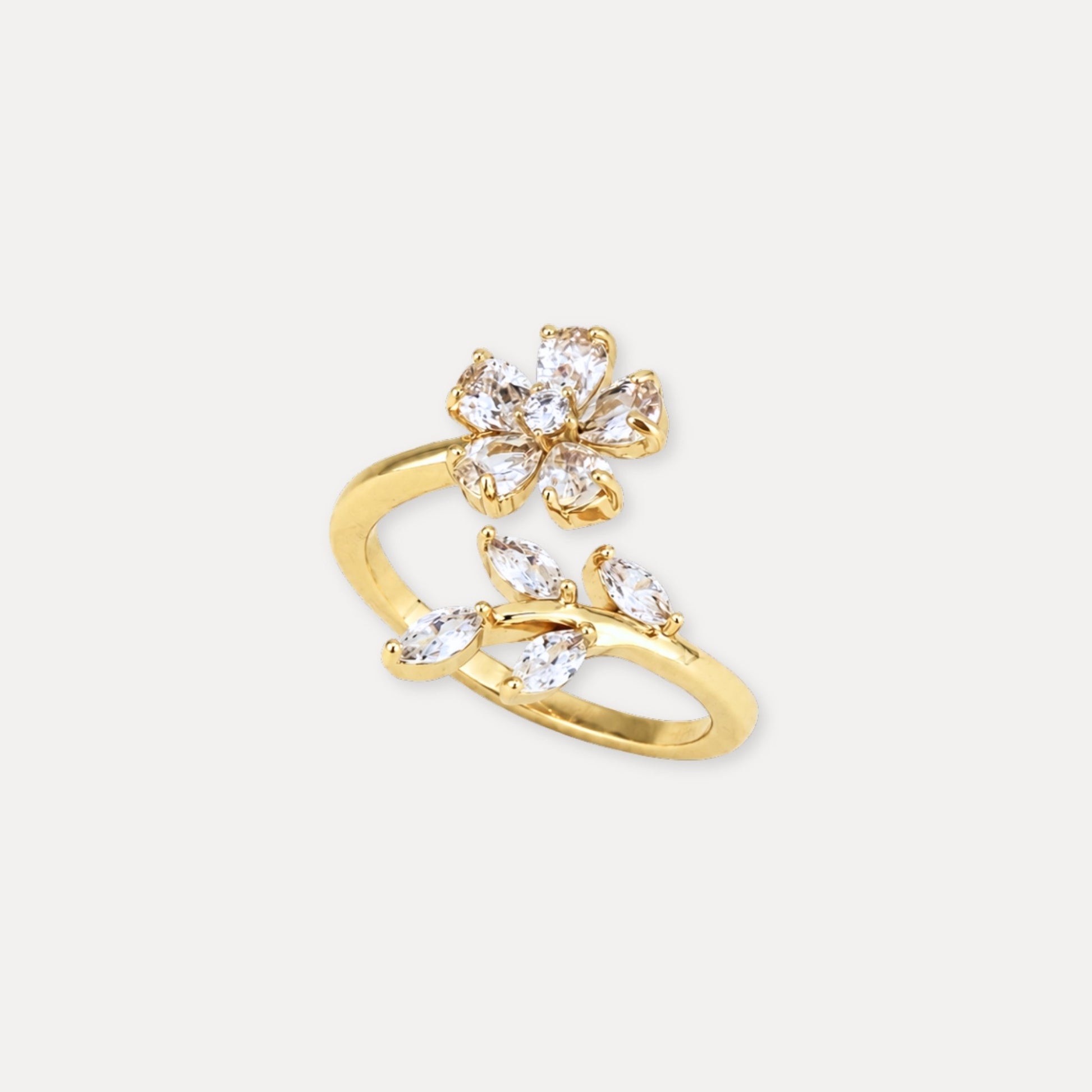 Gold flower and leaf ring with clear zircon stones.