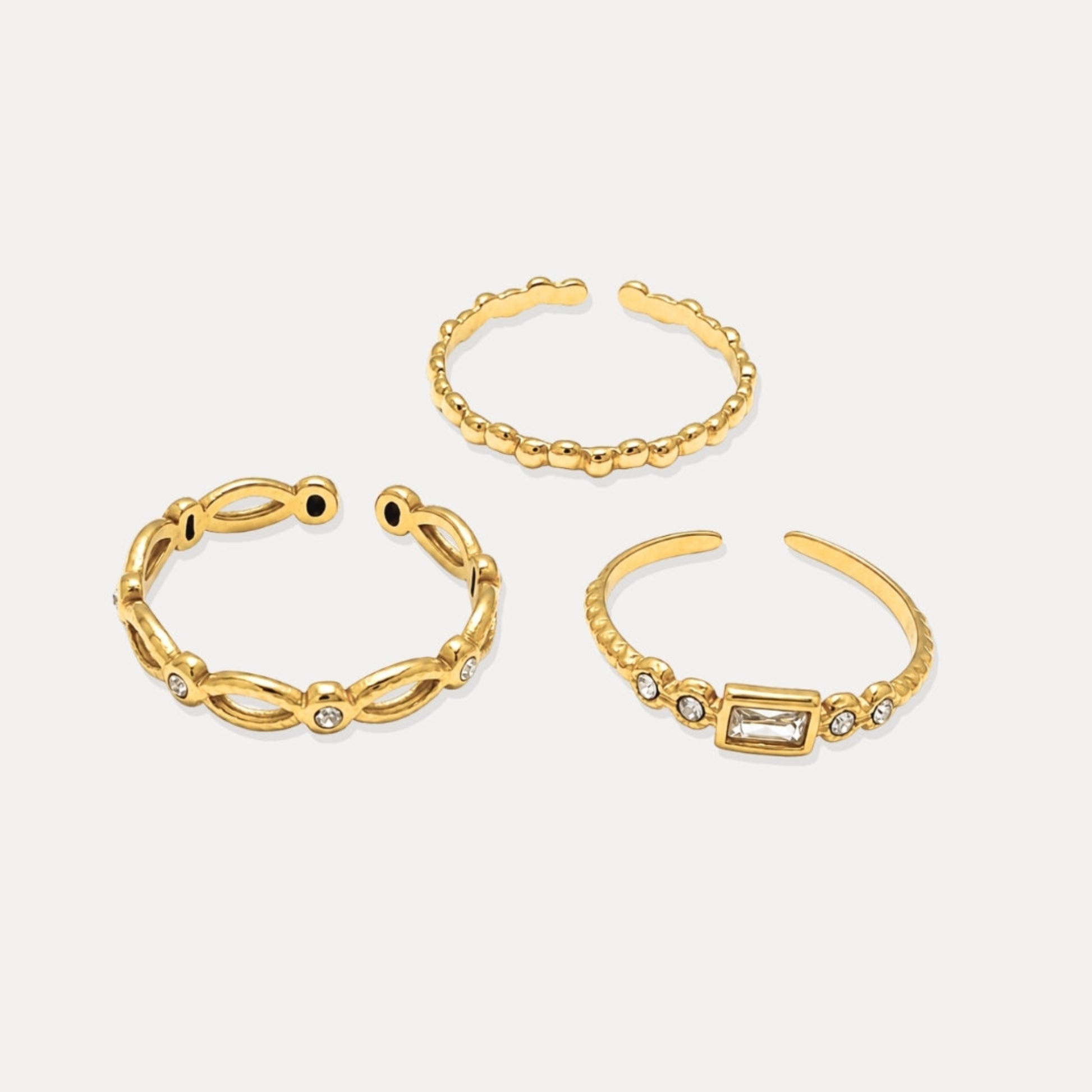 Three gold adjustable open rings with bead texture and cubic zirconia details