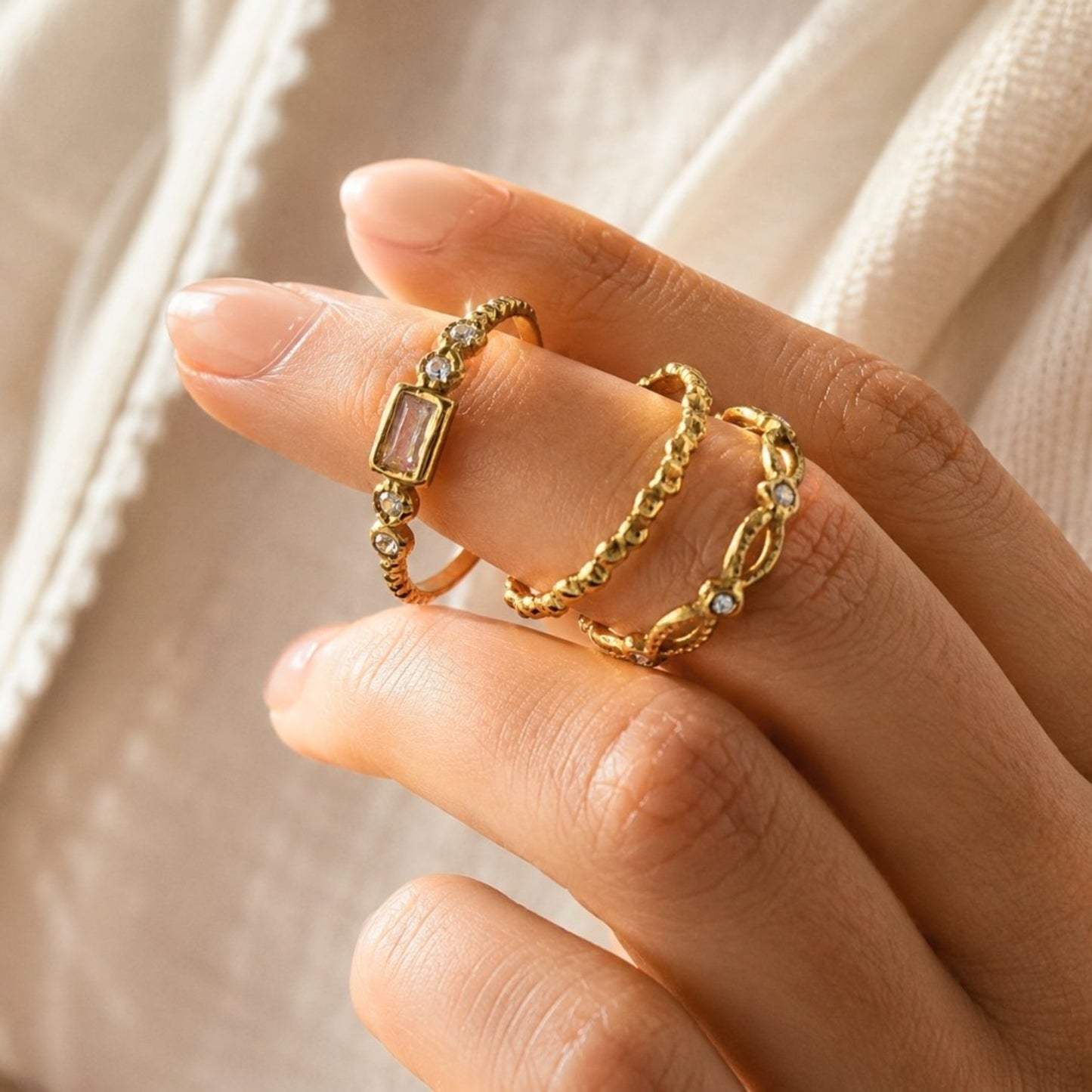 Gold open ring set with CZ accents worn stacked on fingers
