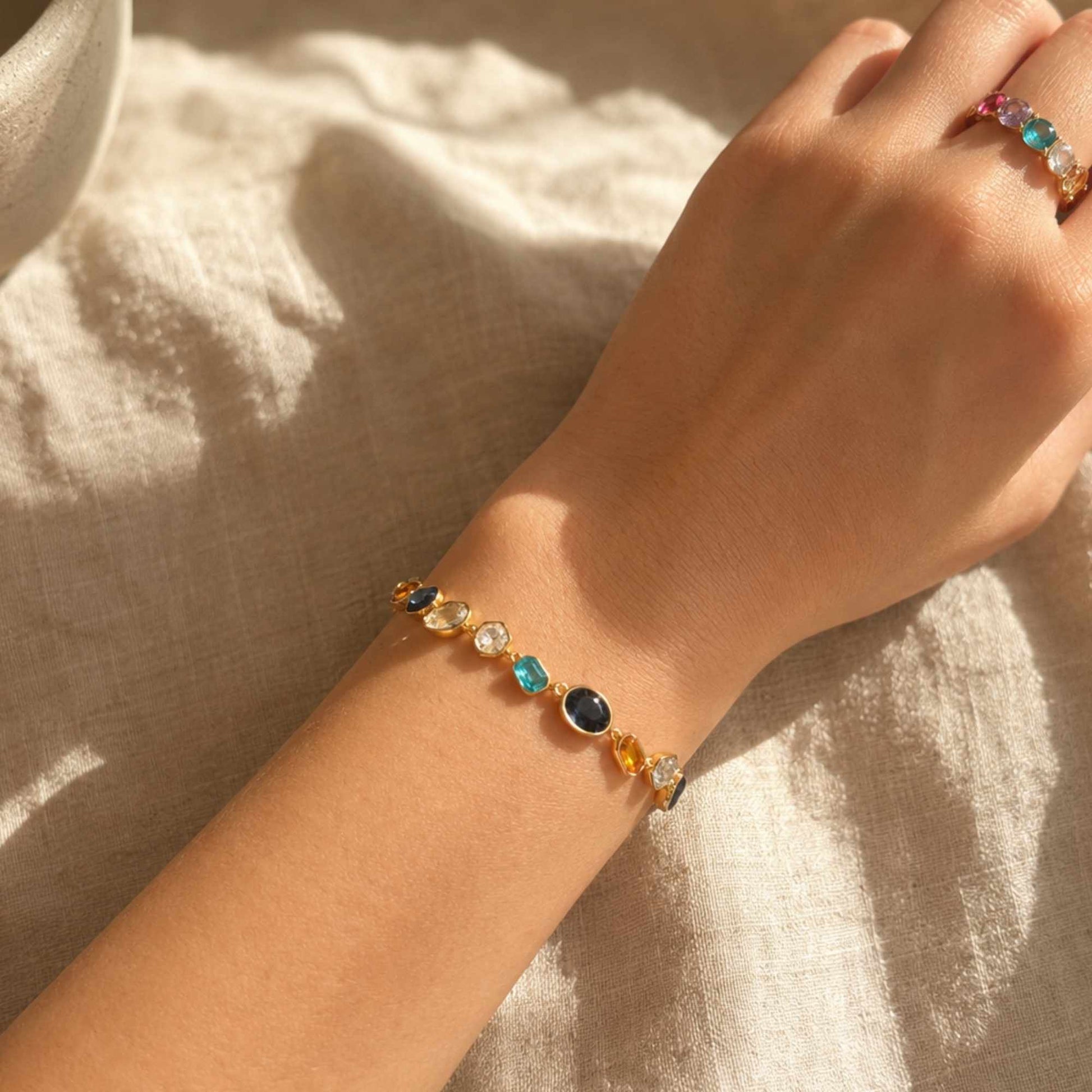 Colorful glass bracelet worn on the wrist in warm natural light