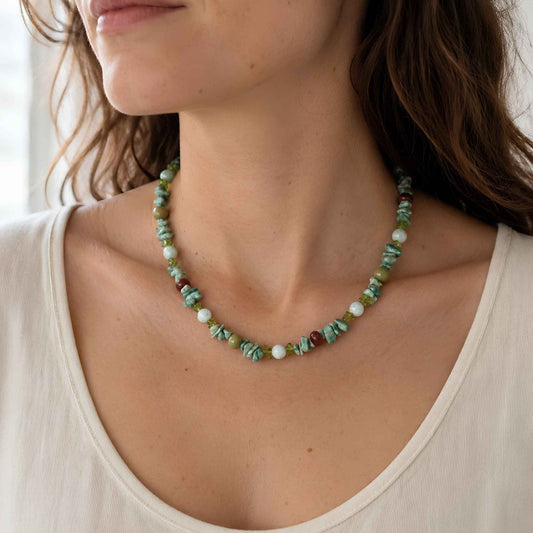 Model wearing a green mixed stone necklace with apatite accents and stainless steel hardware.