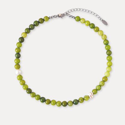 Olive green stone beaded necklace with freshwater pearl and shell accents.