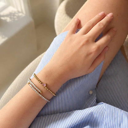 One Heart Bead Bracelet stacked with slim stone-set bracelets for an everyday layered wrist look