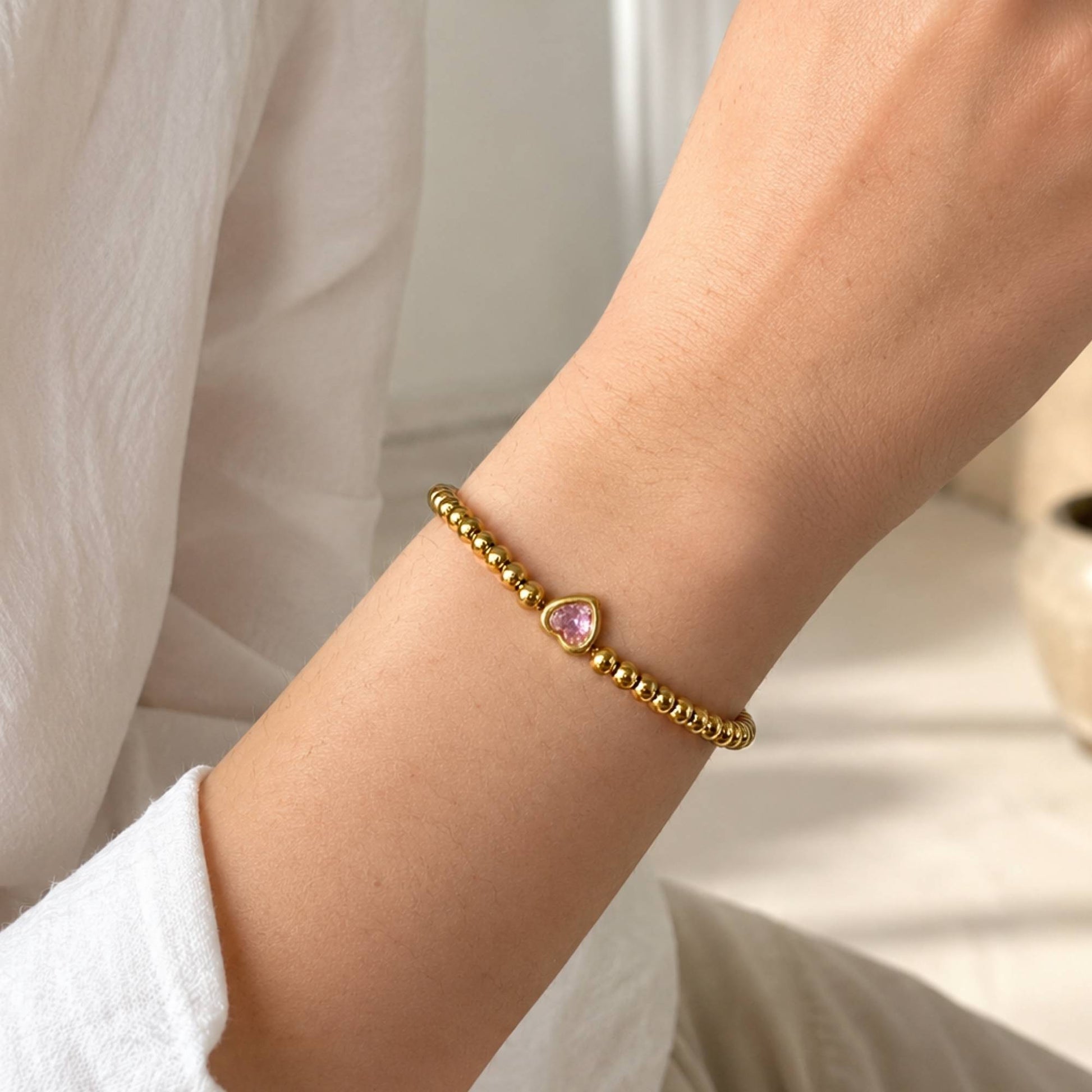 One Heart Bead Bracelet worn alone on the wrist with the pink heart centerpiece facing forward