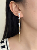 Pace long freshwater pearl drop earring worn in side profile with fine gold-filled chain details.