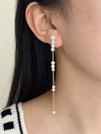 Pace long freshwater pearl drop earring worn in side profile with fine gold-filled chain details.