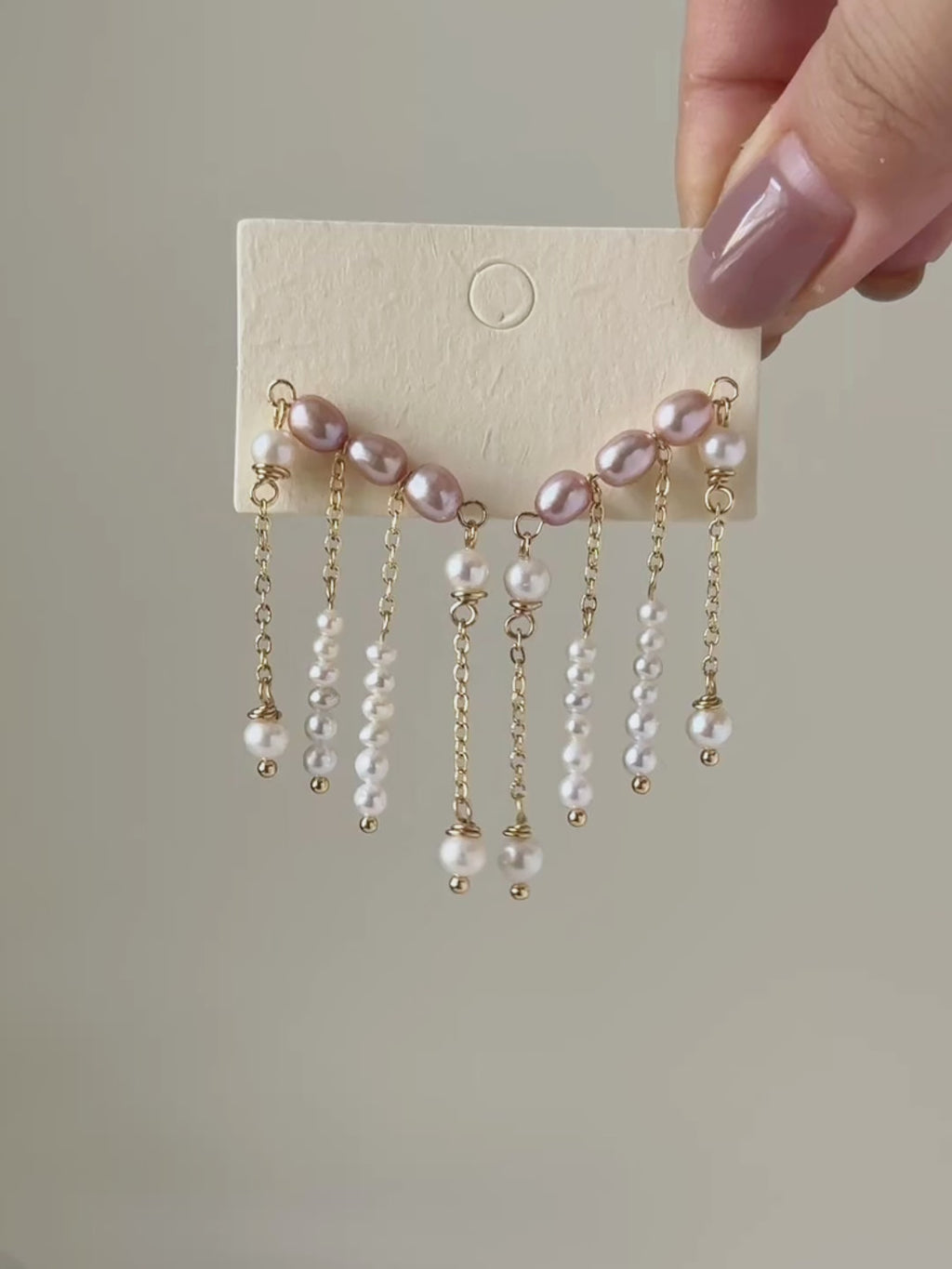 Contour freshwater pearl ear climber earrings shown from full product display to worn view, highlighting the cascading pearl strands and natural movement.