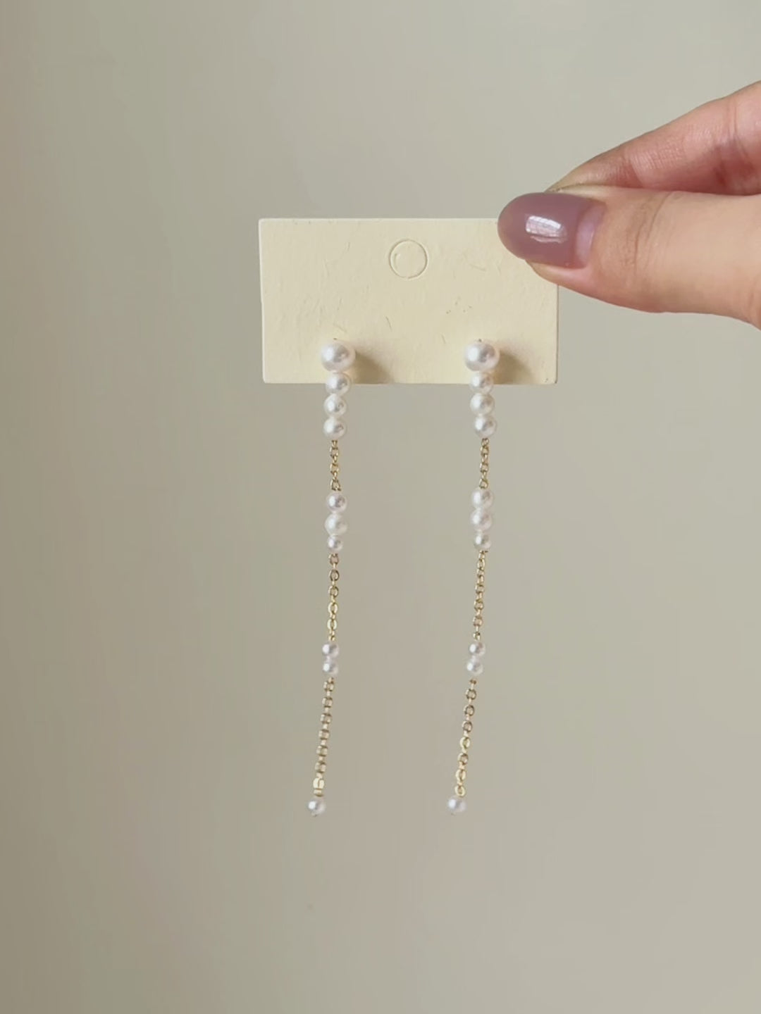Six-second product video transitioning from the full pair on a display card to a worn close-up, highlighting the earrings’ length and fluid movement.