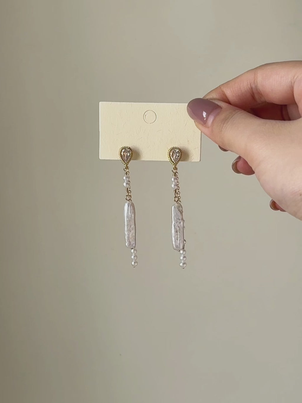 Shift convertible freshwater pearl earrings shown from full product display to worn view, highlighting the layered pearl drops and natural movement.