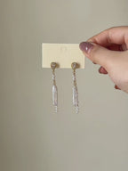 Shift convertible freshwater pearl earrings shown from full product display to worn view, highlighting the layered pearl drops and natural movement.