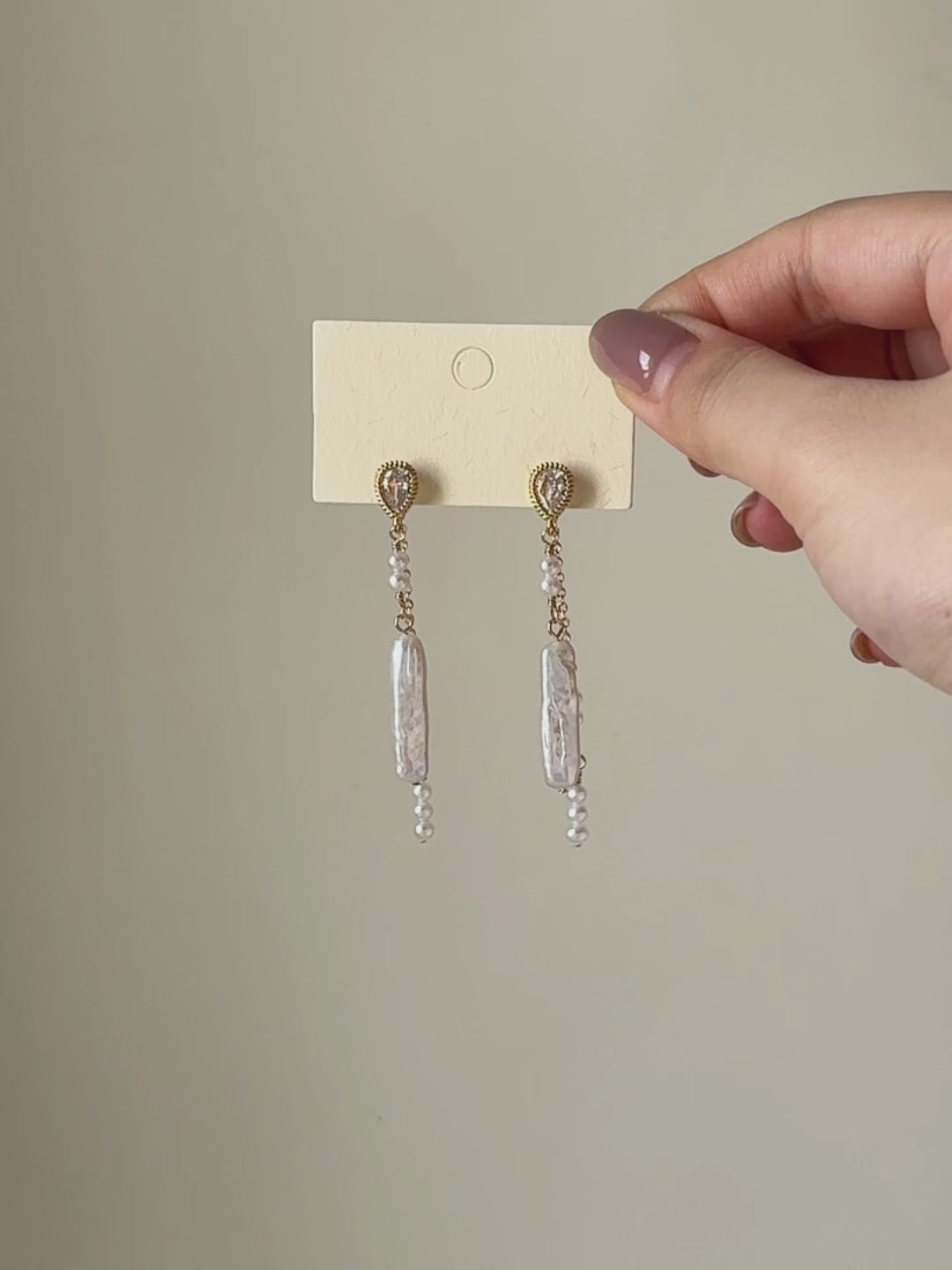 Shift convertible freshwater pearl earrings shown from full product display to worn view, highlighting the layered pearl drops and natural movement.