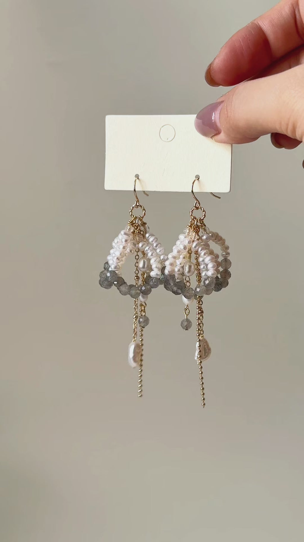 Arc labradorite and freshwater pearl earrings shown from product display to worn view, highlighting the layered design and natural movement.