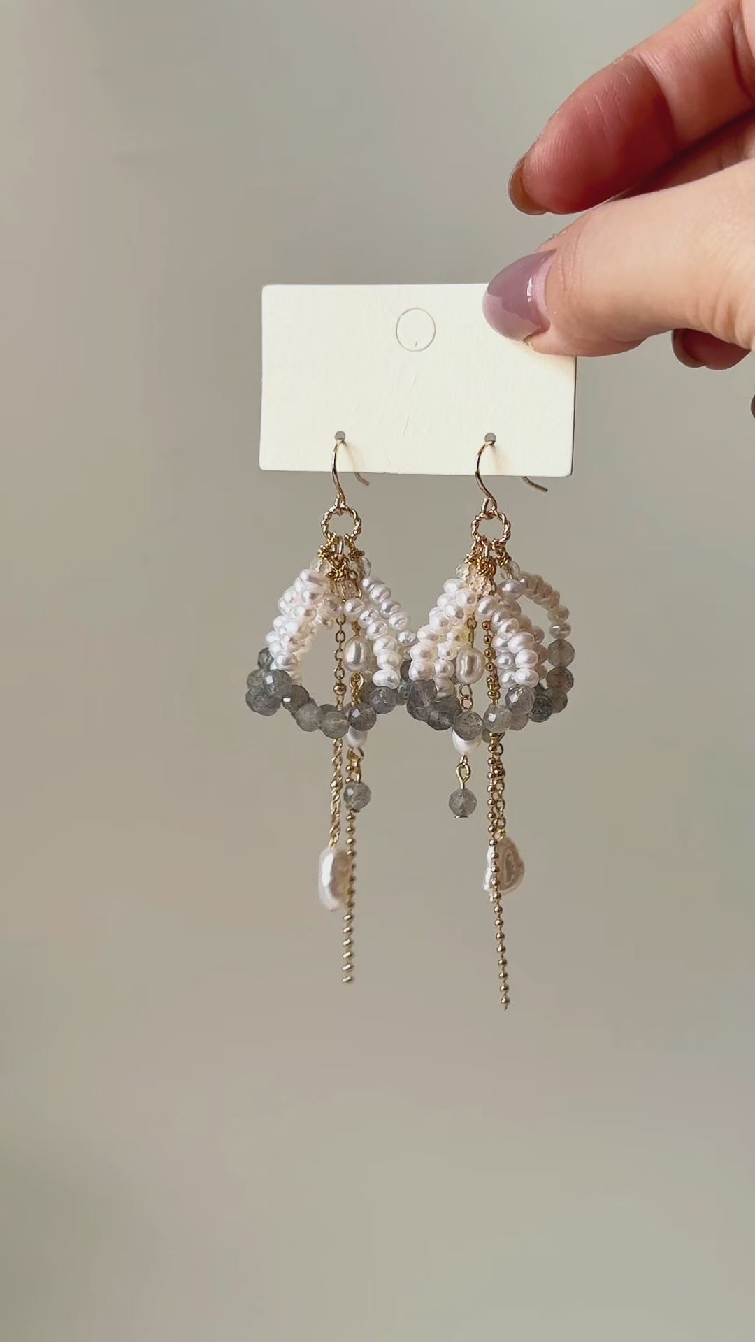 Arc labradorite and freshwater pearl earrings shown from product display to worn view, highlighting the layered design and natural movement.