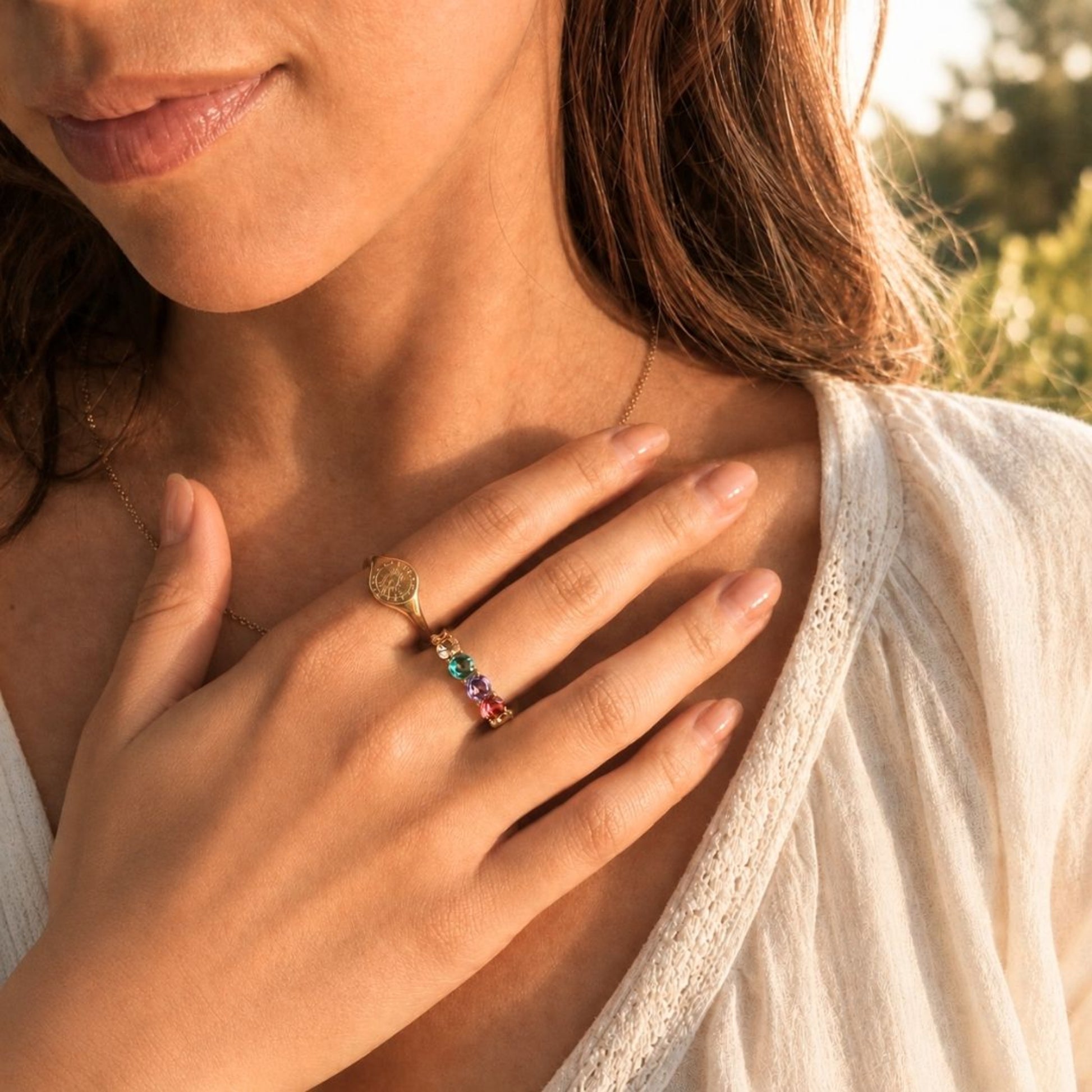 Colorful cubic zirconia ring styled with warm sunlit jewelry