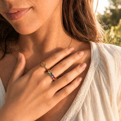 Colorful cubic zirconia ring styled with warm sunlit jewelry