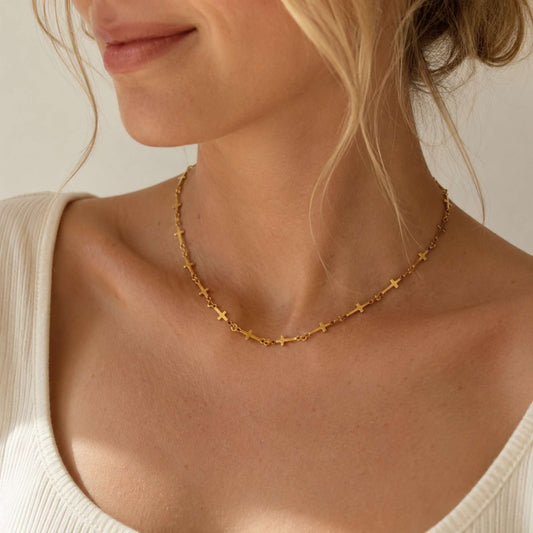 Quiet Faith Cross Chain Necklace worn close to the neckline with repeating gold cross links