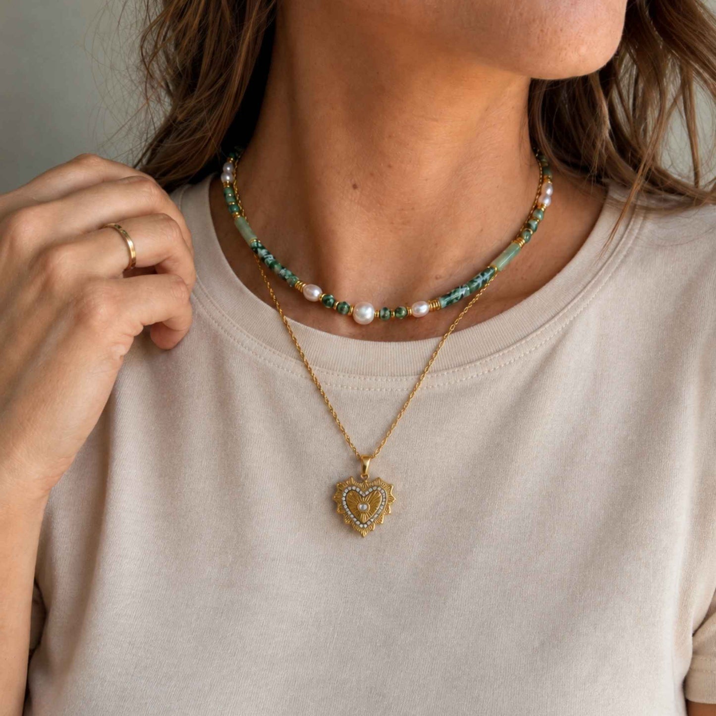 Radiant Heart Pendant Necklace layered below a short green beaded necklace for an everyday styled look
