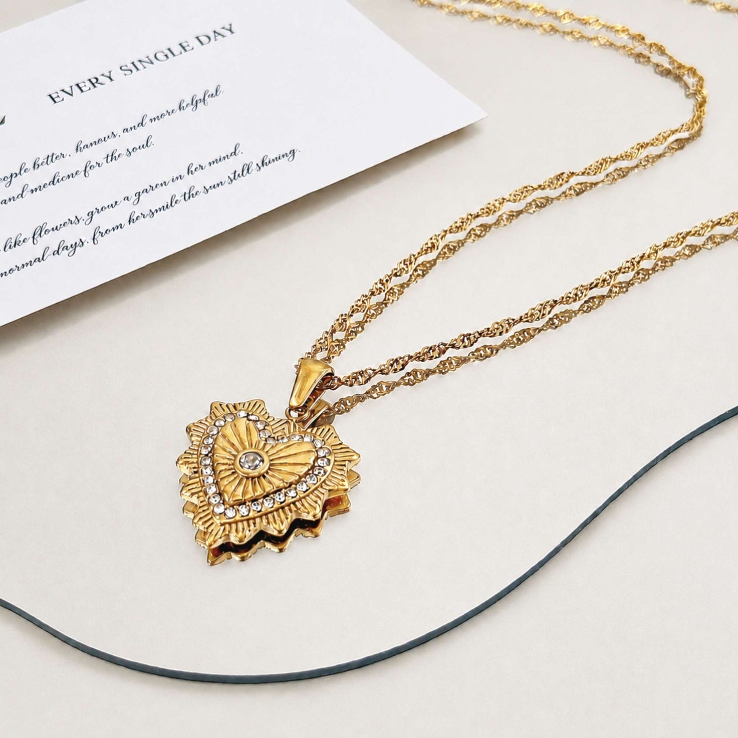 Radiant Heart Pendant Necklace layered below a short green beaded necklace for an everyday styled look