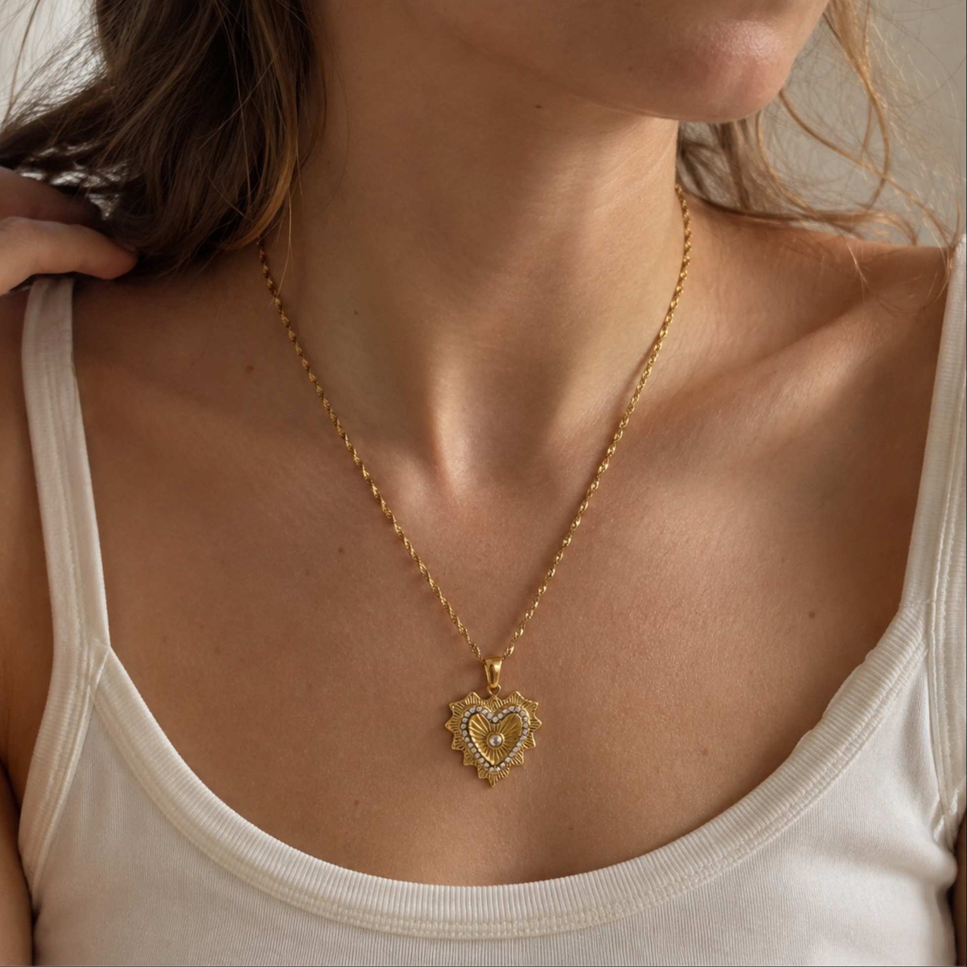 Radiant Heart Pendant Necklace worn alone with a white tank top in warm natural light