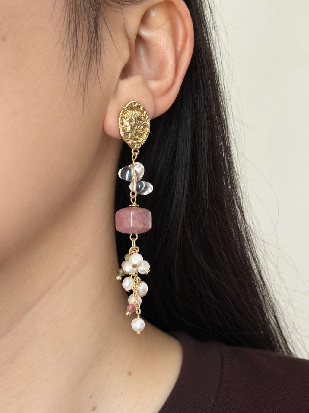 Relic rhodonite pearl earring worn in side profile with clear quartz and clustered gemstone accents.