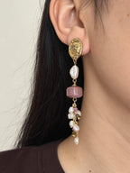 Relic rhodonite pearl earring worn in side profile with a freshwater baroque pearl and gemstone cascade.