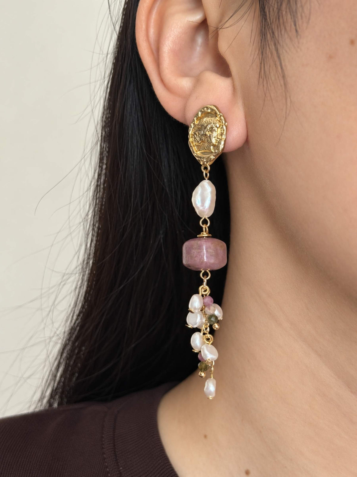 Relic rhodonite pearl earring worn in side profile with a freshwater baroque pearl and gemstone cascade.