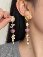 Relic gemstone pearl earrings shown worn and held beside the ear, highlighting their length and natural stone details.