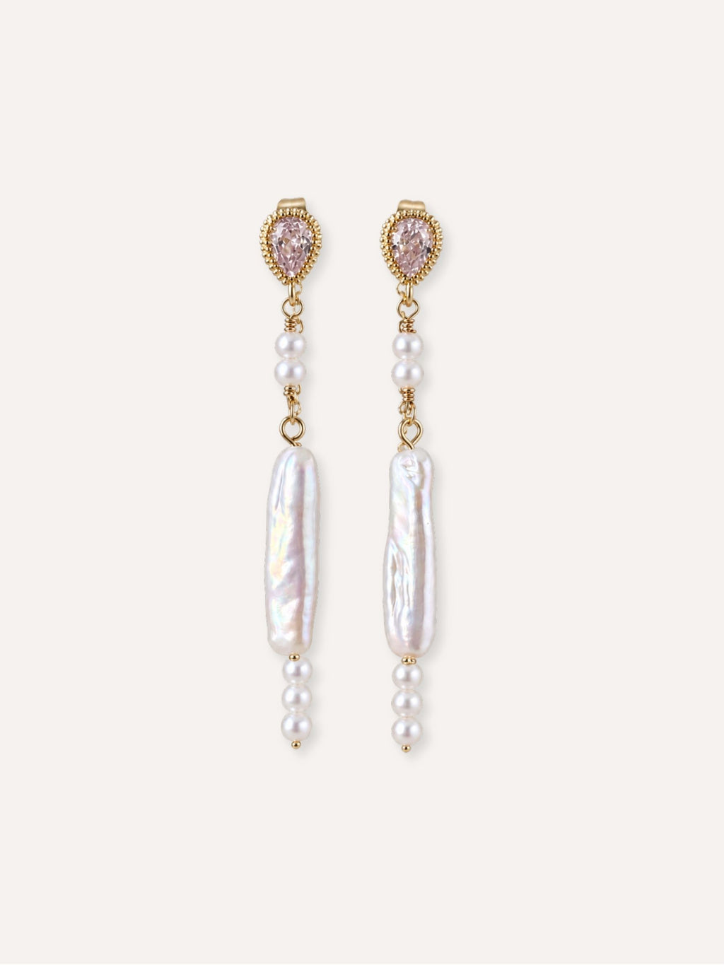 Pair of Shift freshwater baroque pearl earrings with cubic zirconia studs and delicate pearl accents.
