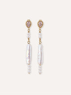 Pair of Shift freshwater baroque pearl earrings with cubic zirconia studs and delicate pearl accents.