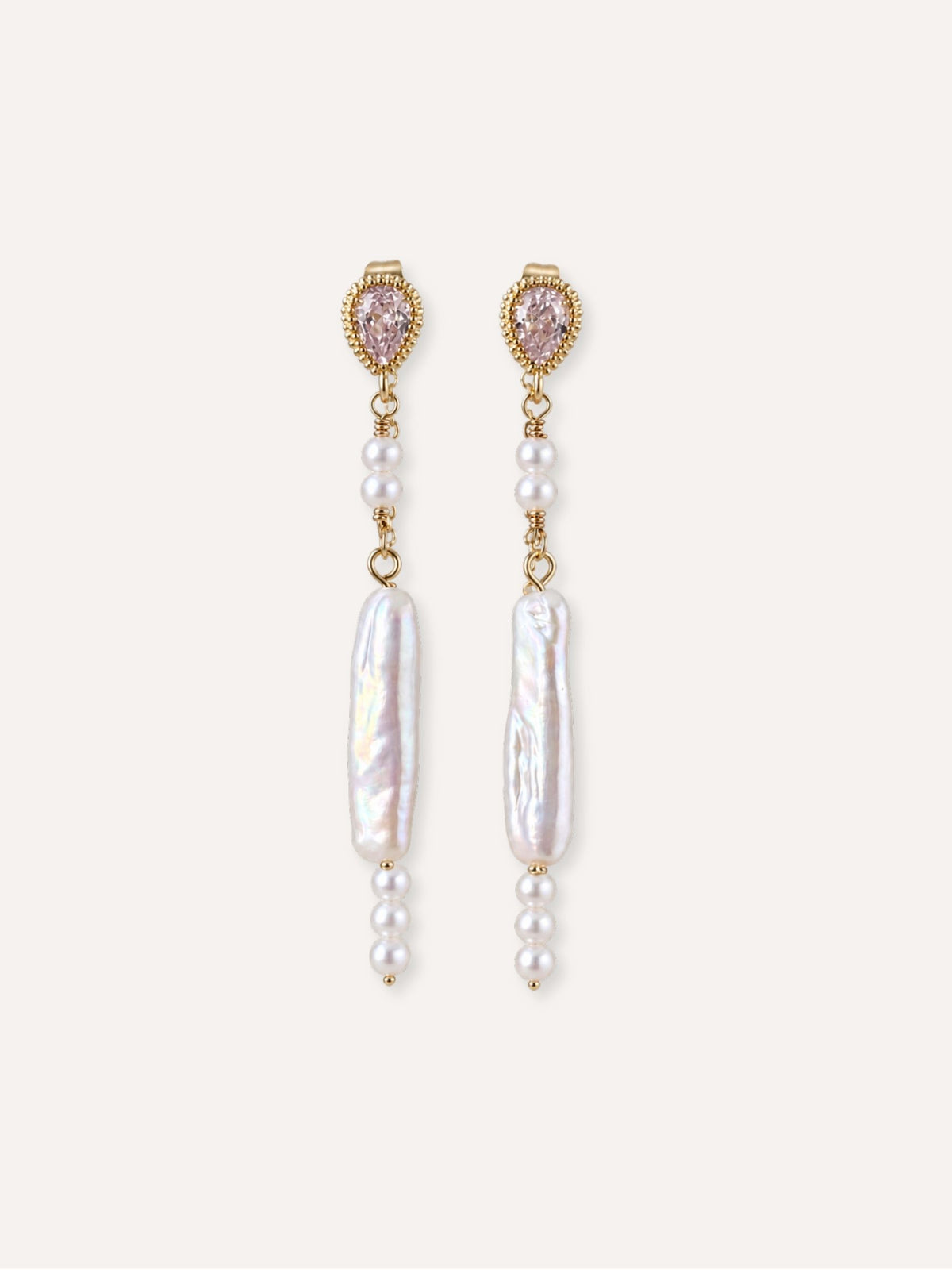 Pair of Shift freshwater baroque pearl earrings with cubic zirconia studs and delicate pearl accents.